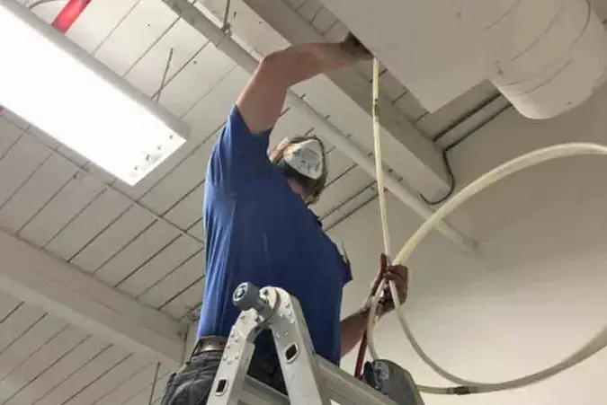 COIT technician cleaning air ducts with truck-mounted equipment